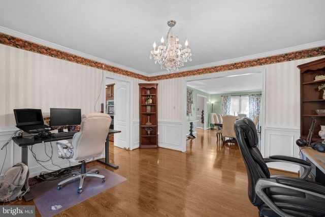 a view of a livingroom with workspace and a window