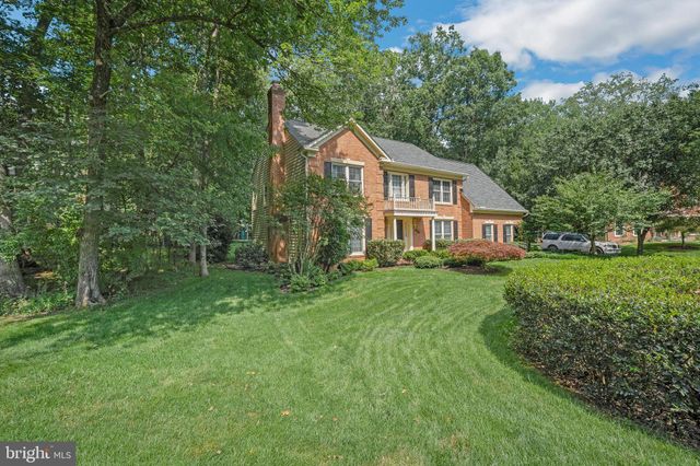 a front view of a house with yard and green space