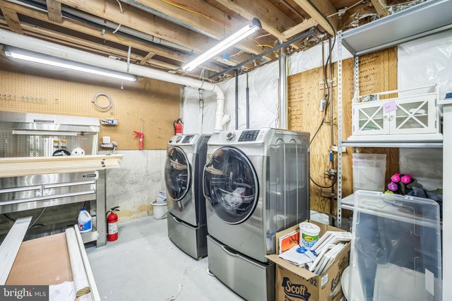 a utility room with dryer washer and a large window