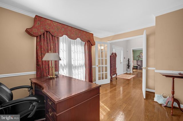 a view of a room with furniture and wooden floor