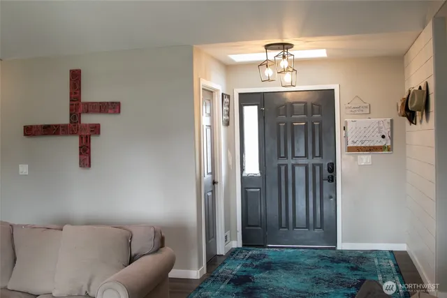 a living room with furniture and a chandelier