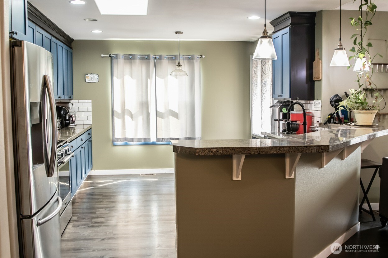 217 Noble Street Sumas, WA 98295 - Photo 5 of 19 a kitchen with stainless steel appliances a sink and a refrigerator