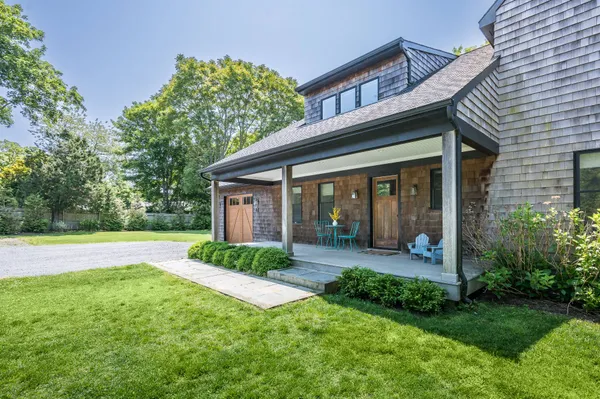 a view of a house with a yard and plants