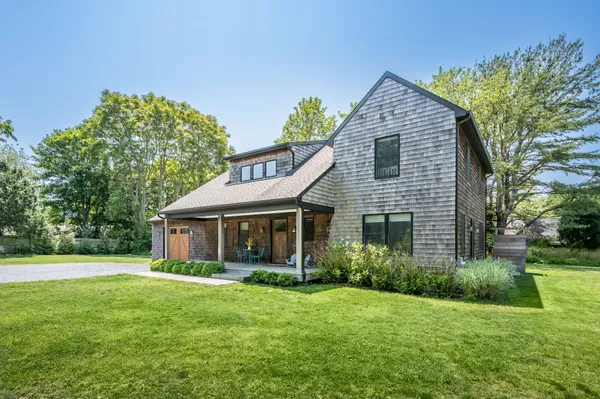 a view of a house with a backyard