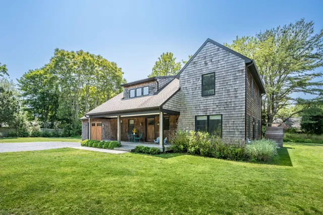 a view of a house with a backyard