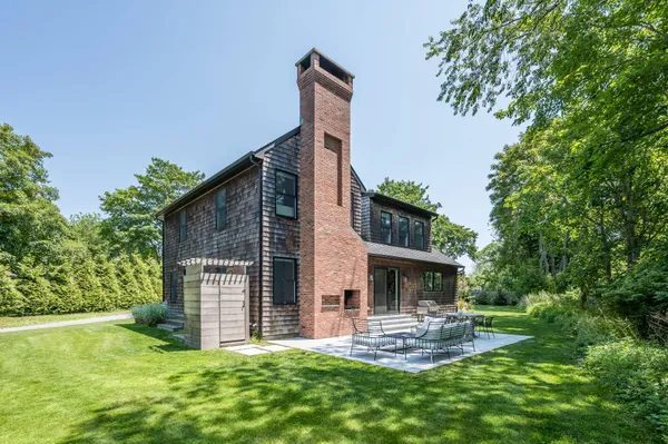 a view of a house with a yard and sitting area