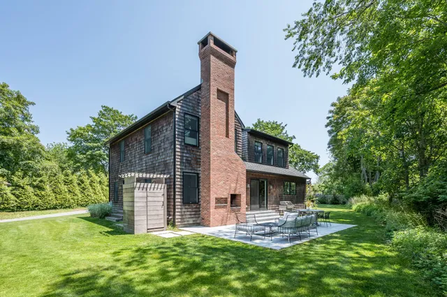 a view of a house with a yard and sitting area
