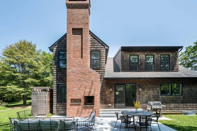 a view of house with outdoor seating area