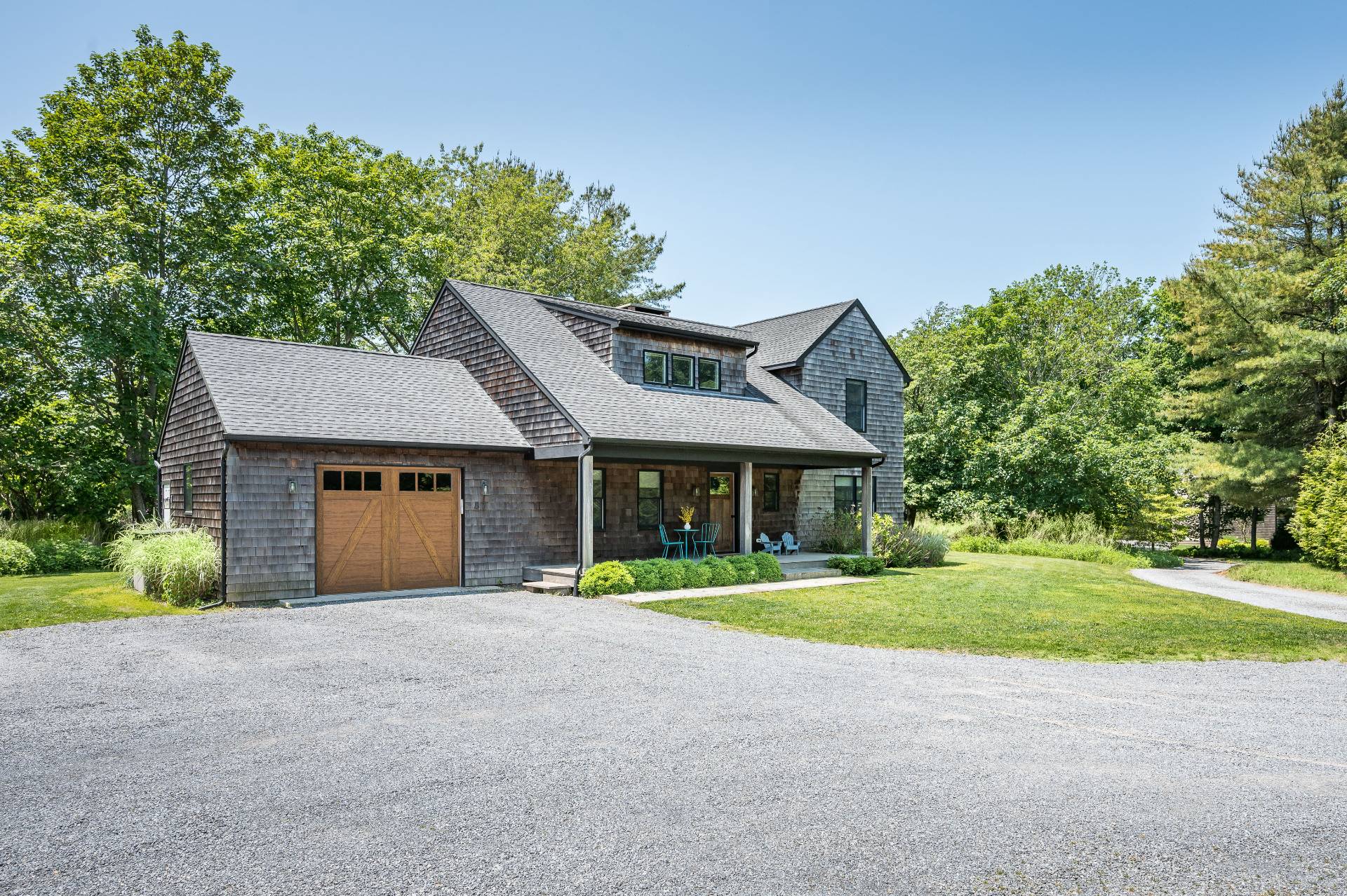 87 Accabonac Road East Hampton, NY 11937 - Photo 20 of 20 a front view of a house with a yard and garage