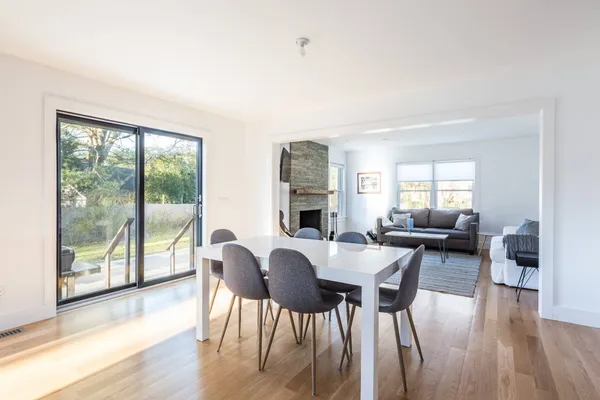 a view of a dining room with furniture and wooden floor