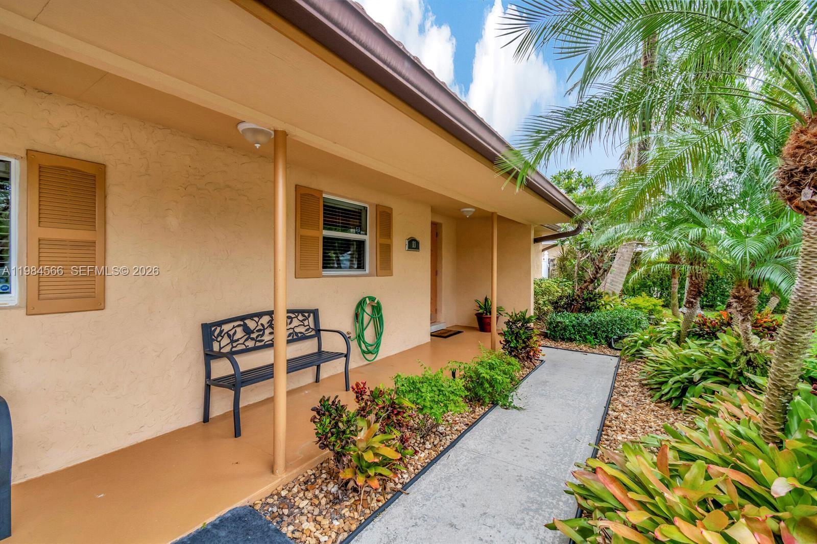 11 Forest Hills Lane Boca Raton, FL 33431 - Photo 21 of 24 a front view of a house with garden