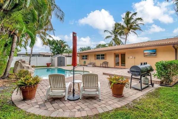 a front view of a house with patio furniture
