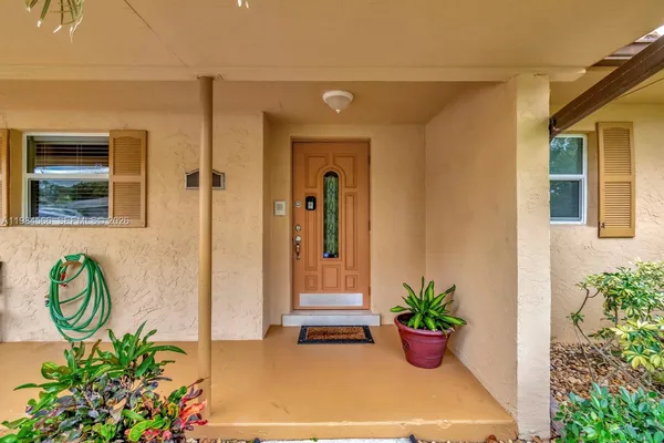 a front view of a house with a potted plant
