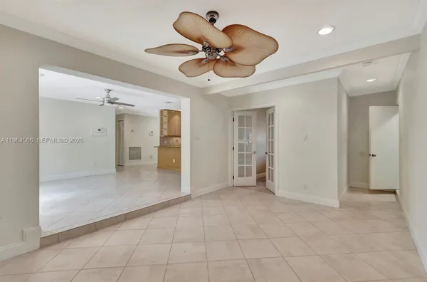 a view of an empty room and a bathroom