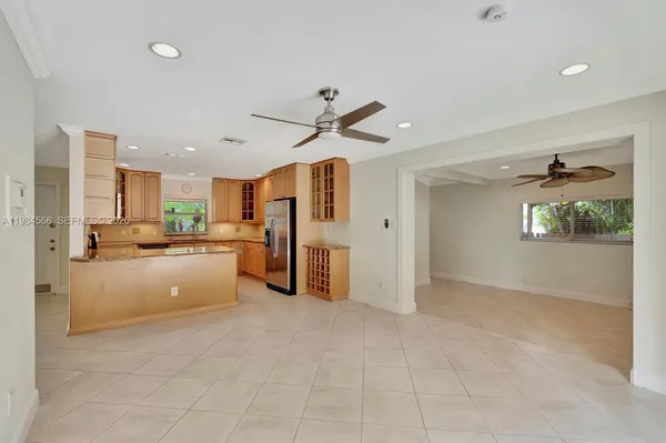 a large white kitchen with refrigerator stove and a sink