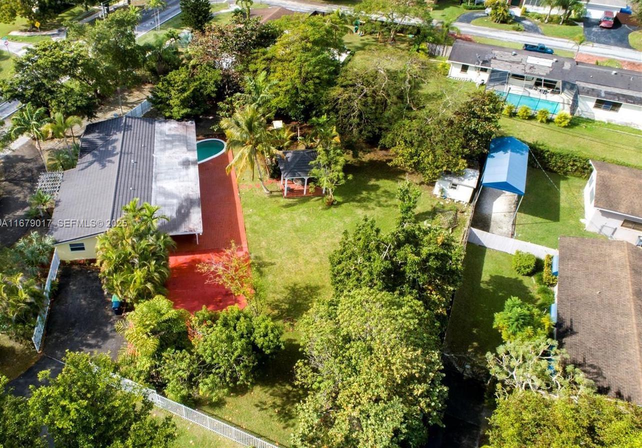 an aerial view of a house with a yard and lake view