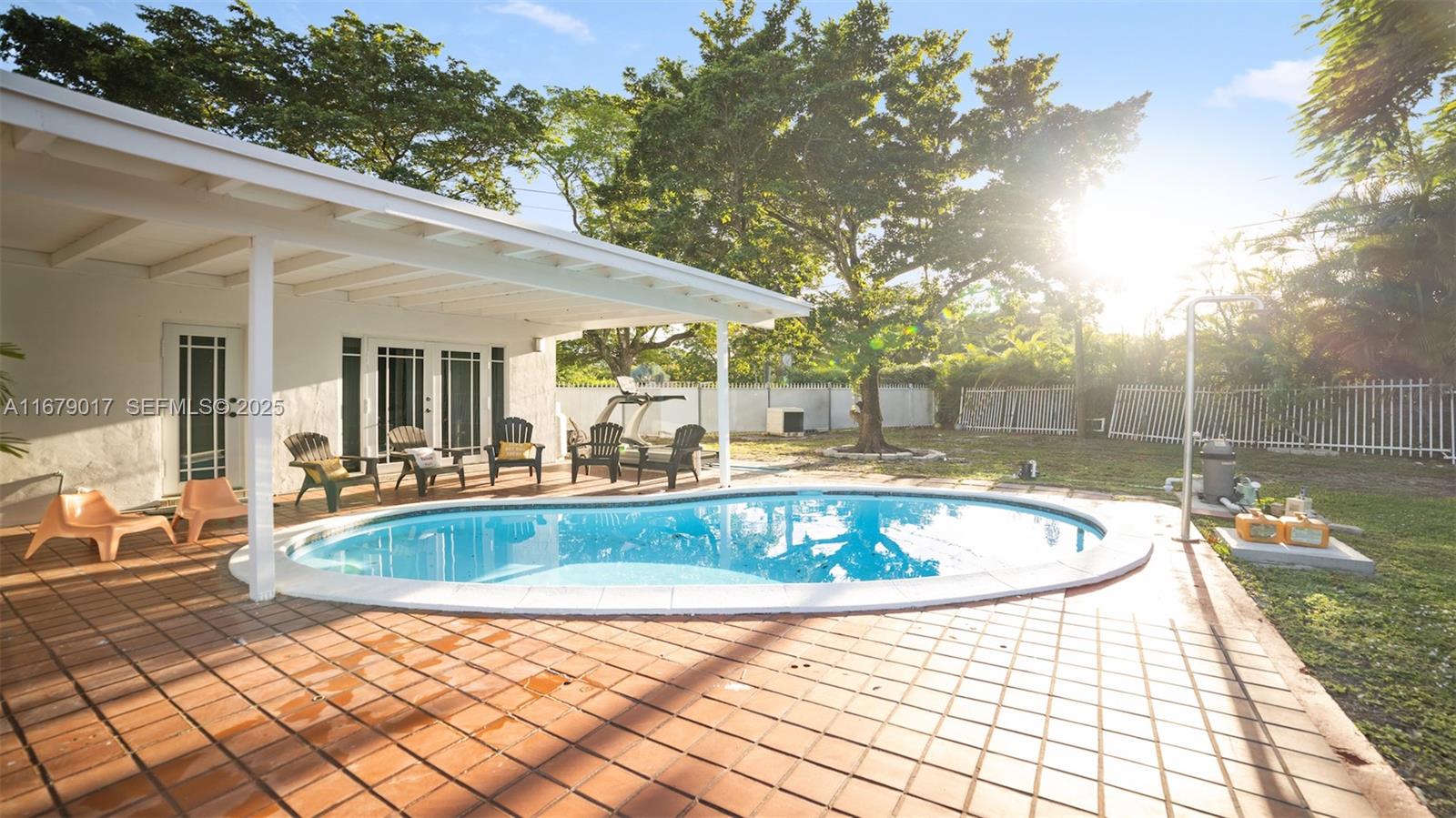 13550 Southwest 99th Place Miami, FL 33176 - Photo 6 of 25 a view of a swimming pool with a lounge chair