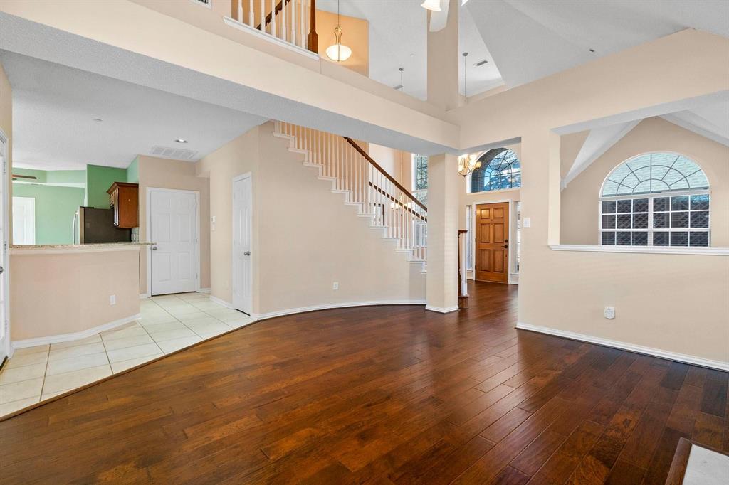 14588 Poe Court Addison, TX 75001 - Photo 5 of 28 a view of an empty room with wooden floor and a window