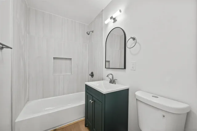 a bathroom with a sink toilet and tub