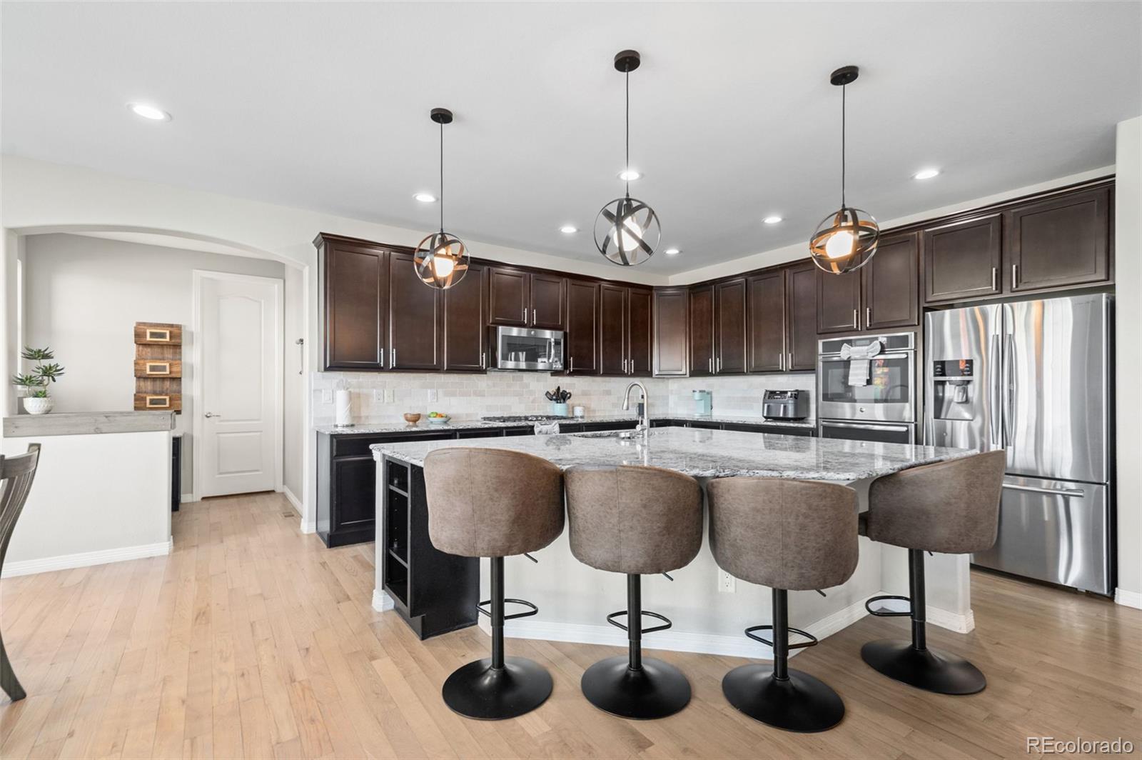 2910 El Nido Way Castle Rock, CO 80108 - Photo 11 of 50 a kitchen with lots of counter space and stainless steel appliances