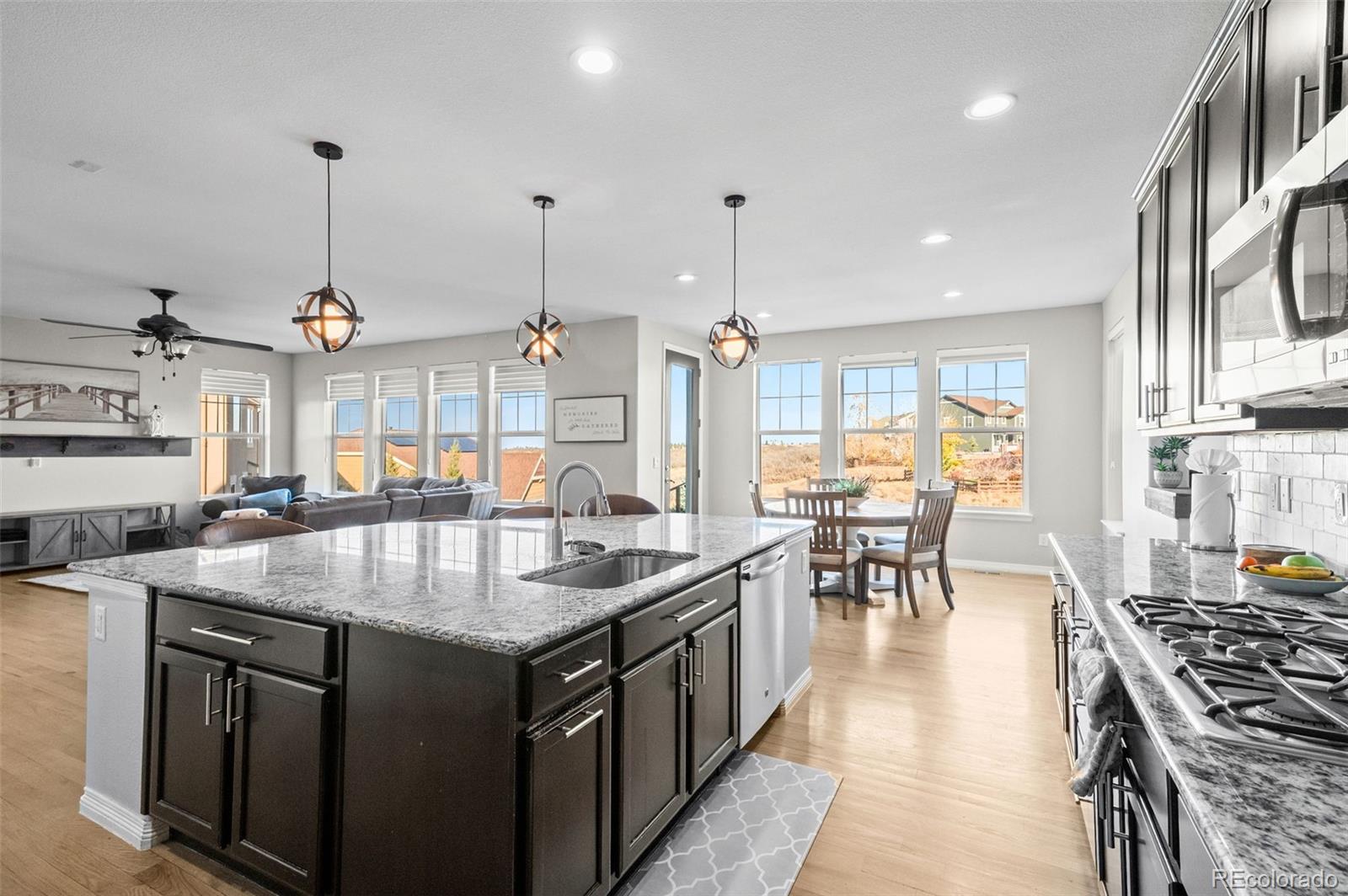 2910 El Nido Way Castle Rock, CO 80108 - Photo 13 of 50 a kitchen with stainless steel appliances granite countertop a stove and chairs