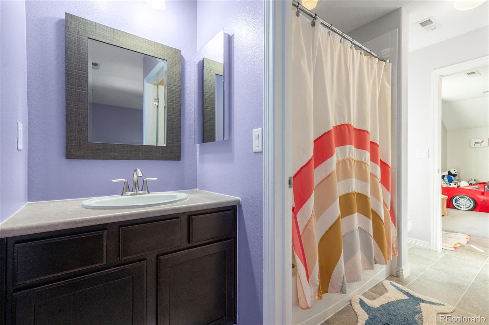 2910 El Nido Way Castle Rock, CO 80108 - Photo 27 of 50 a bathroom with a sink and a mirror