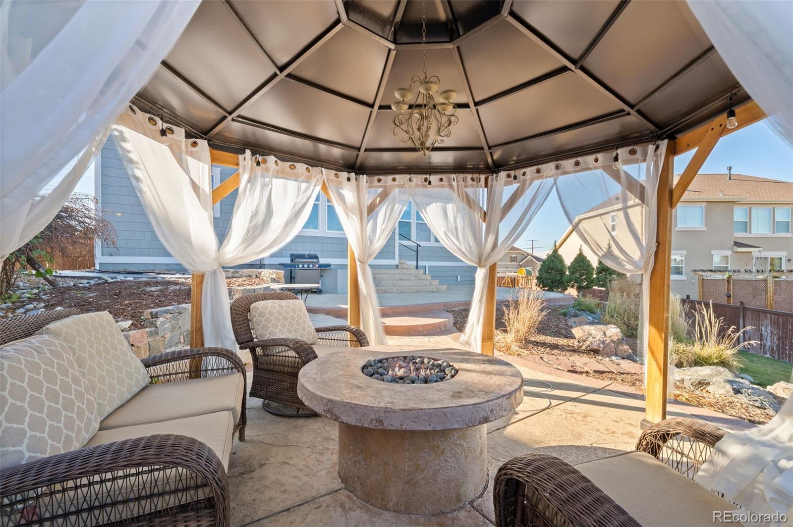 2910 El Nido Way Castle Rock, CO 80108 - Photo 40 of 50 a view of porch with a table and chairs
