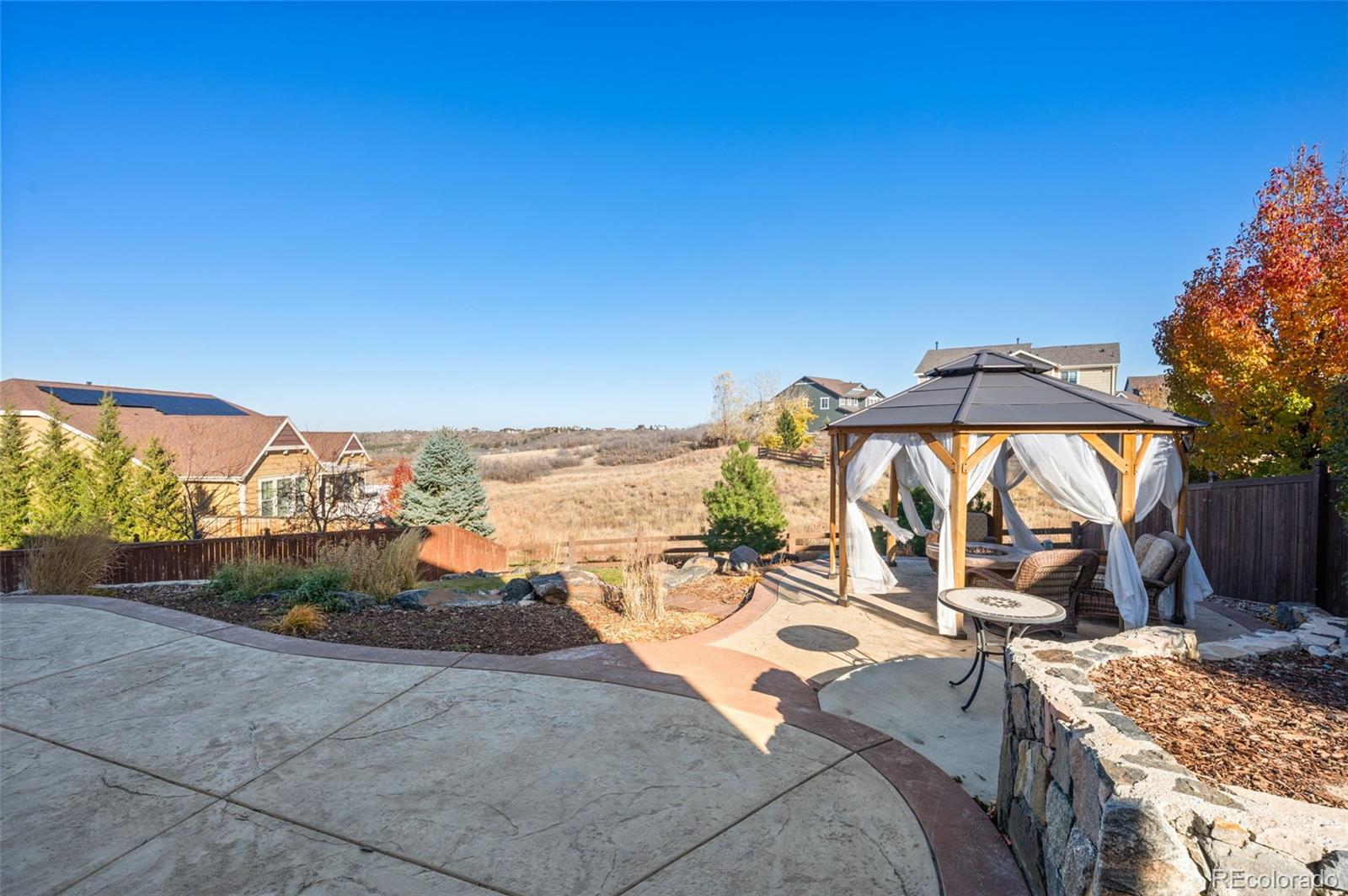 2910 El Nido Way Castle Rock, CO 80108 - Photo 42 of 50 a view of a terrace with a table and chairs under an umbrella