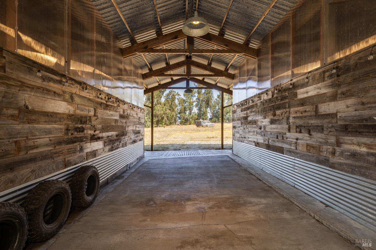 3150 Pepper Road Petaluma, CA 94952 - Photo 64 of 85 Center bay behind the barn for car storage or farm equipment. The storage bays are on either side of this center space.