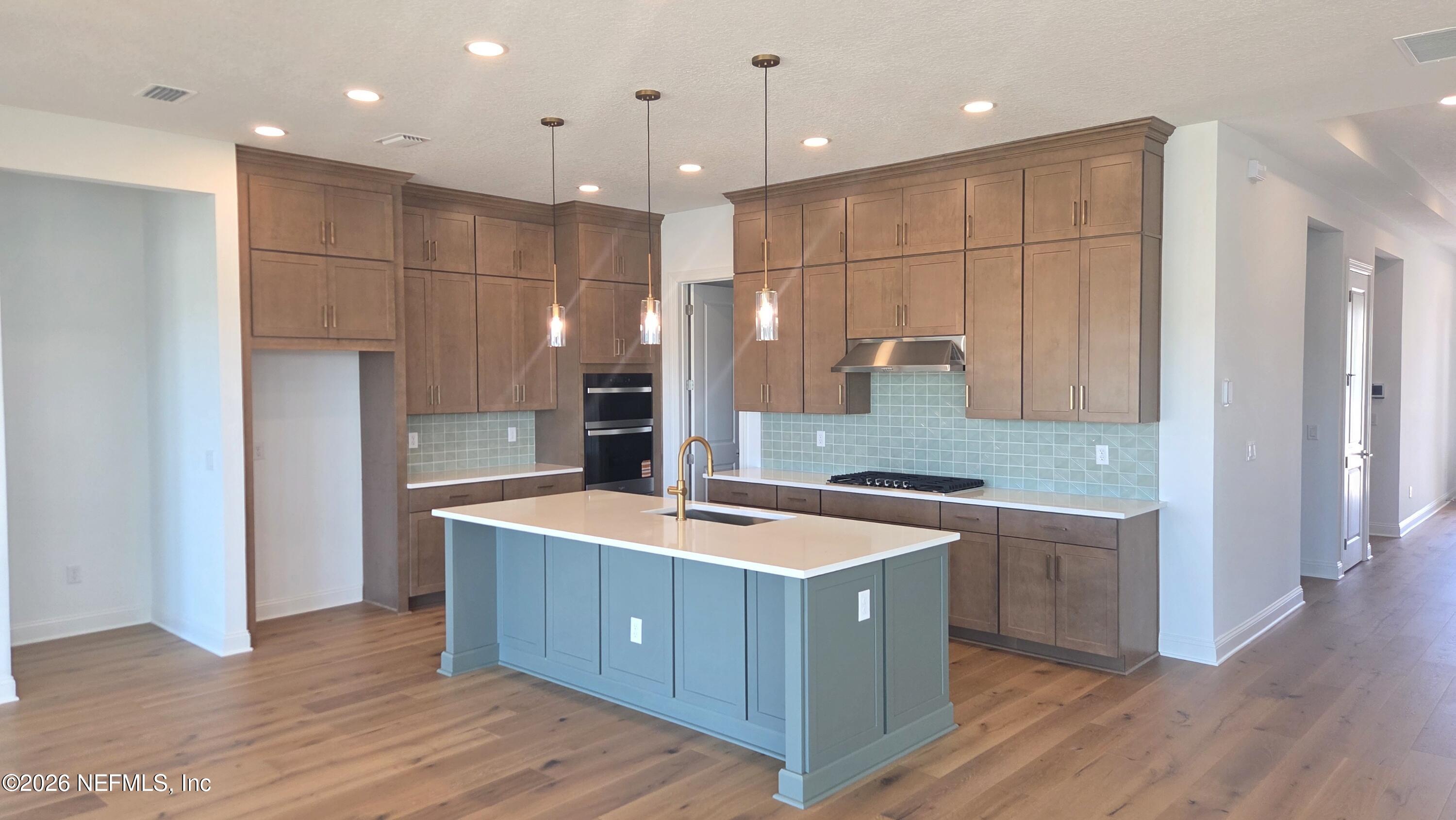 429 Bismarck Palm Road St. Augustine, FL 32092 - Photo 4 of 6 a kitchen with kitchen island granite countertop a sink and a refrigerator