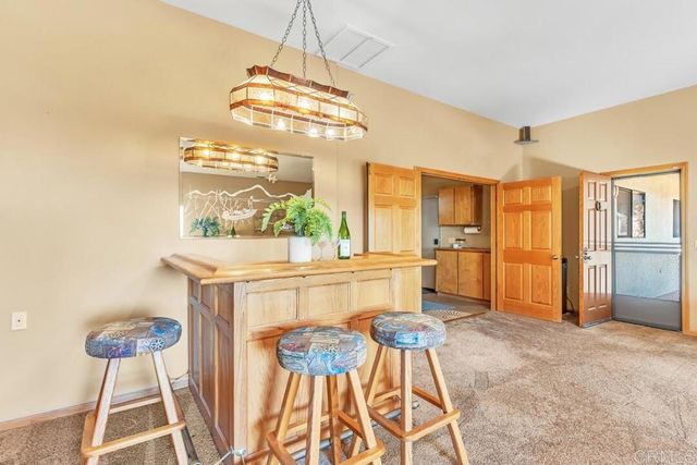 a kitchen with stainless steel appliances kitchen island granite countertop furniture and a chandelier