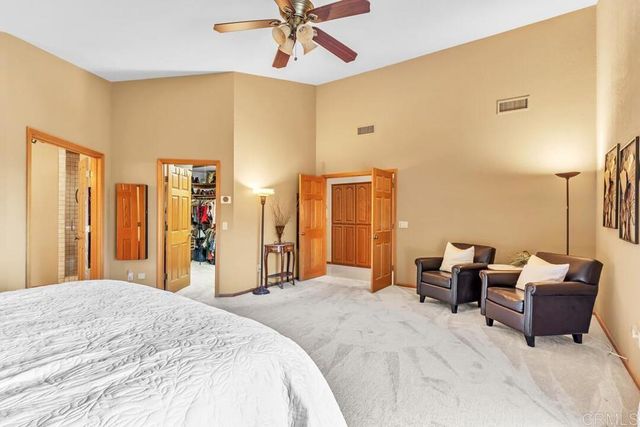 a bedroom with a bed and ceiling fan