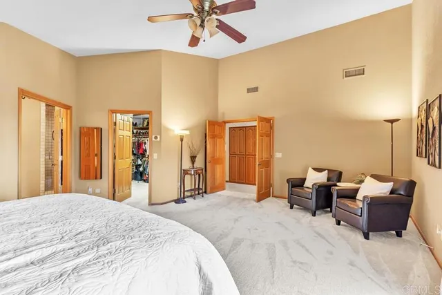 a bedroom with a bed and ceiling fan