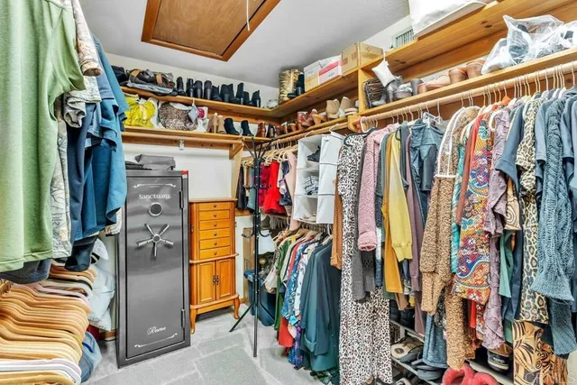 a view of walk in closet with clothes