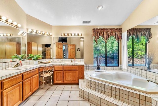 a large kitchen with a large window and cabinets