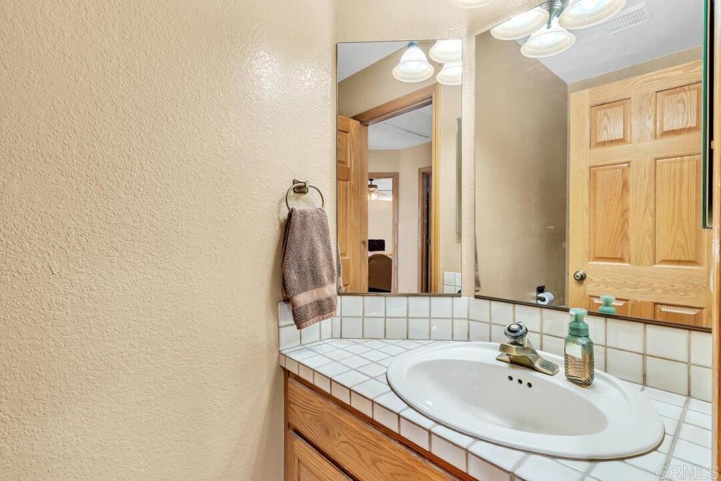 2302 Shaylene Way Alpine, CA 91901 - Photo 23 of 46 a bathroom with a sink and a mirror