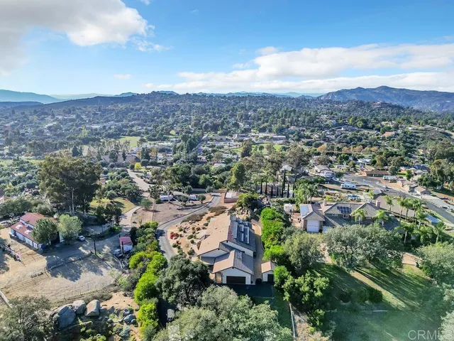 an aerial view of residential house with green space