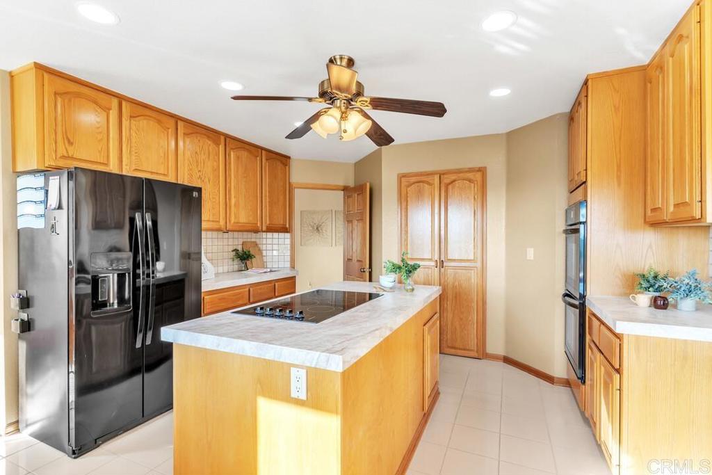 2302 Shaylene Way Alpine, CA 91901 - Photo 6 of 46 a kitchen that has a lot of cabinets stainless steel appliances and a window
