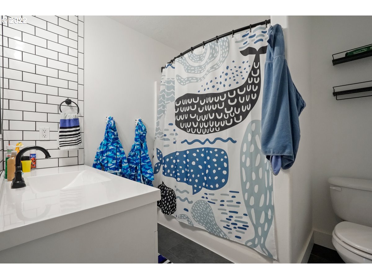 1370 Childers Road Arlington, OR 97812 - Photo 16 of 31 a bathroom with a sink a toilet and a shower curtain