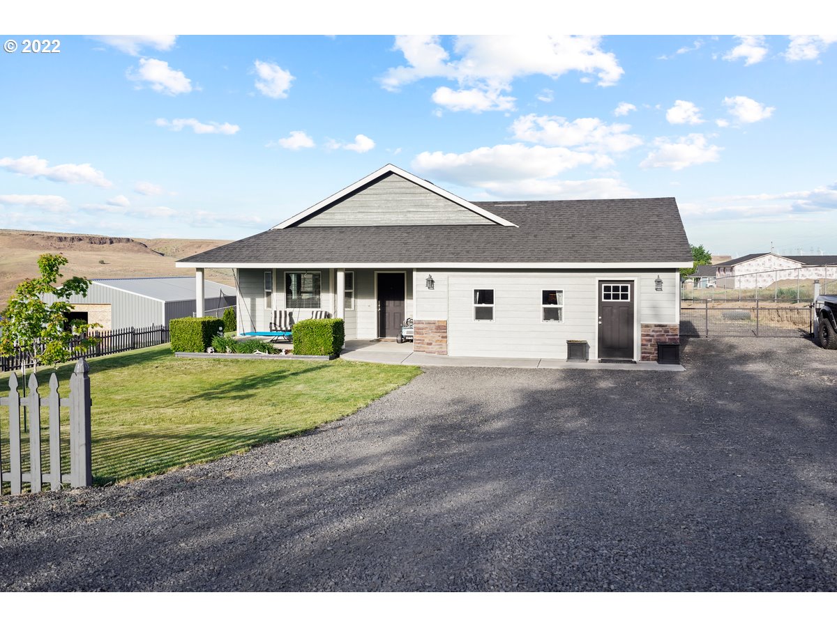 1370 Childers Road Arlington, OR 97812 - Photo 3 of 31 a view of a white house next to a yard with a fountain