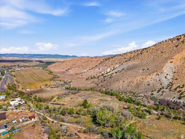 811 East Canyon Road Mayfield, UT 84643 - Photo 3 of 57 Expansive undeveloped land bordering a natural creek bed, featuring mature vegetation and direct access to a paved road