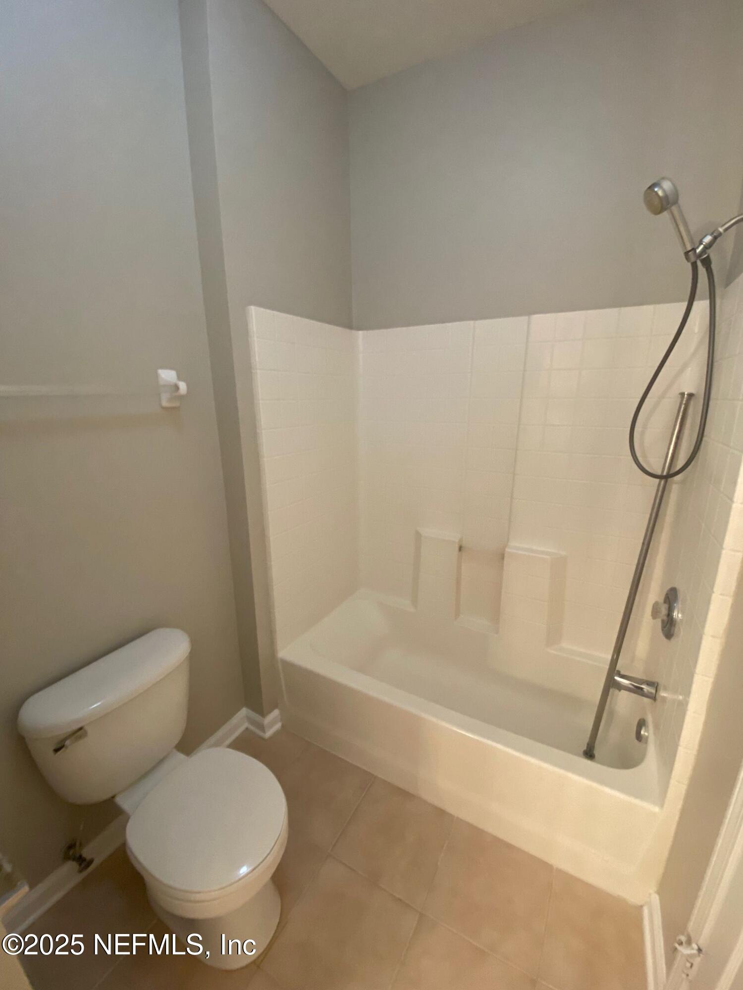 7990 Baymeadows Road, Unit 929 Jacksonville, FL 32256 - Photo 15 of 26 a white toilet sitting next to a bath tub and a shower