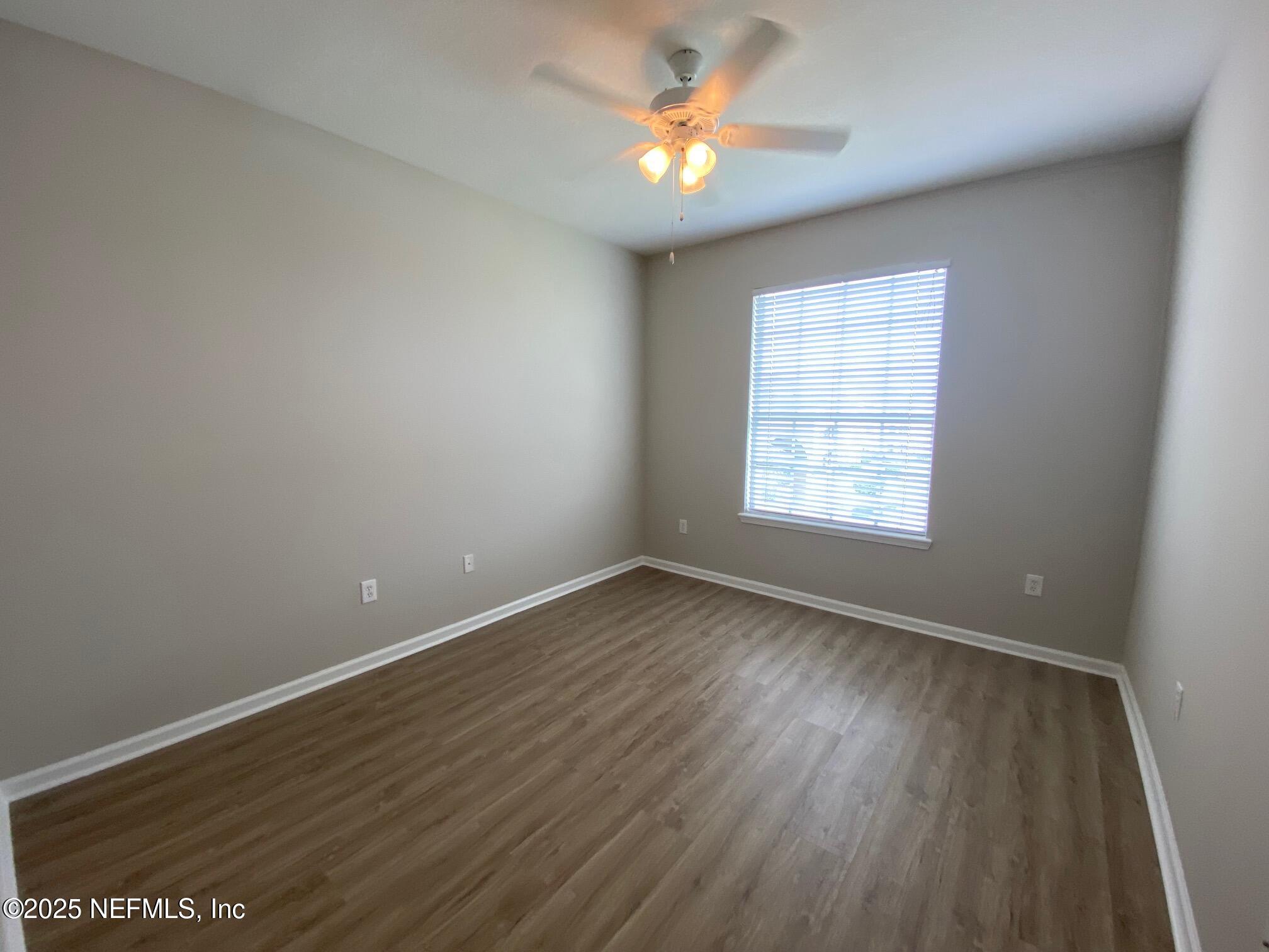 7990 Baymeadows Road, Unit 929 Jacksonville, FL 32256 - Photo 20 of 26 an empty room with wooden floor and windows