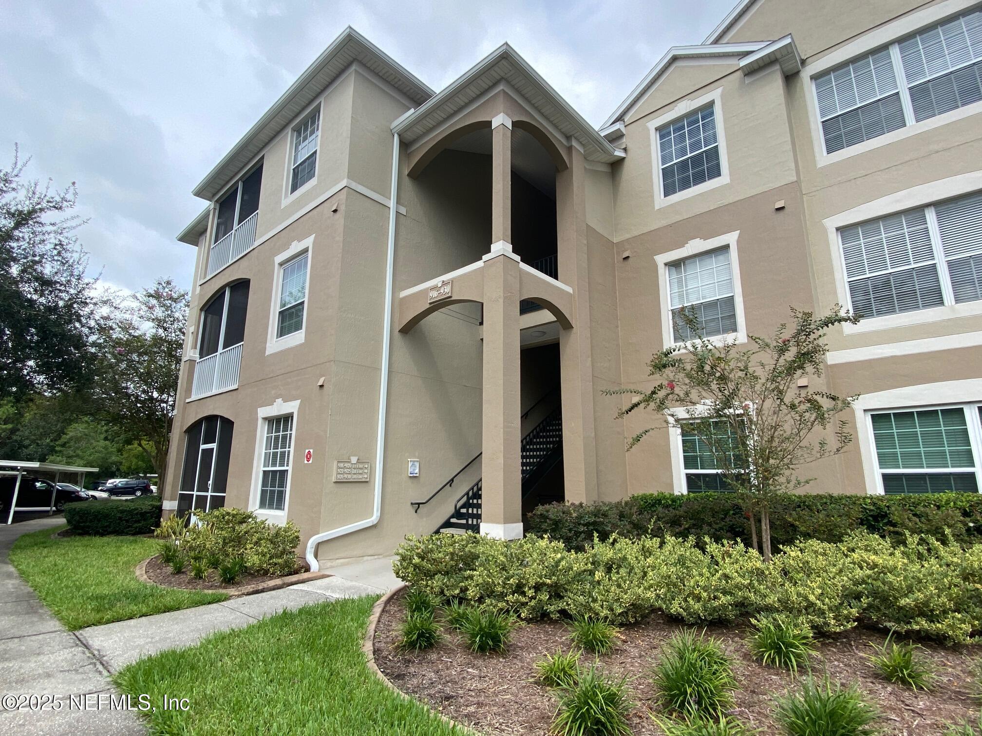 7990 Baymeadows Road, Unit 929 Jacksonville, FL 32256 - Photo 2 of 26 front view of a house with a yard