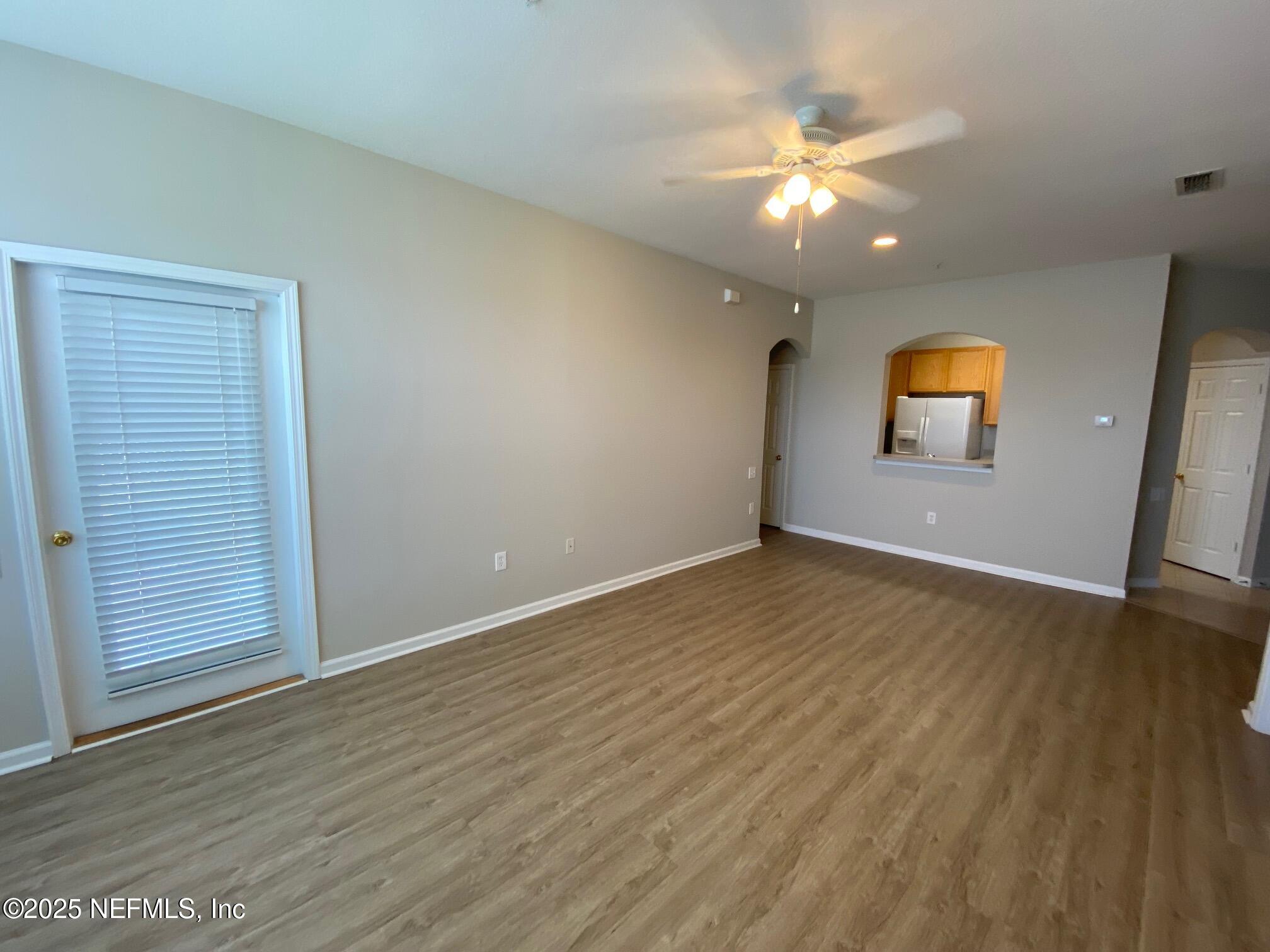 7990 Baymeadows Road, Unit 929 Jacksonville, FL 32256 - Photo 6 of 26 an empty room with wooden floor and windows