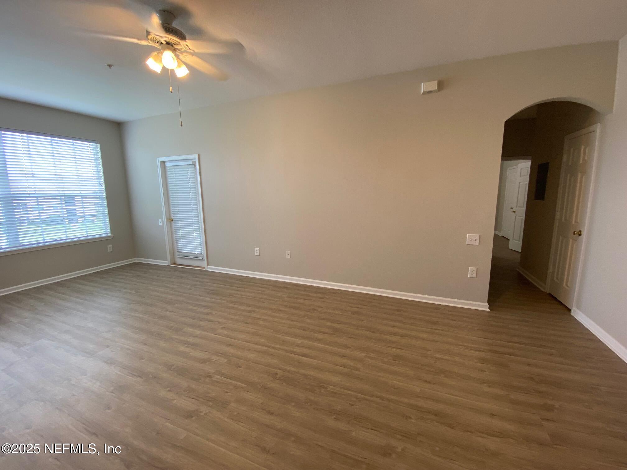 7990 Baymeadows Road, Unit 929 Jacksonville, FL 32256 - Photo 7 of 26 wooden floor in an empty room with a window