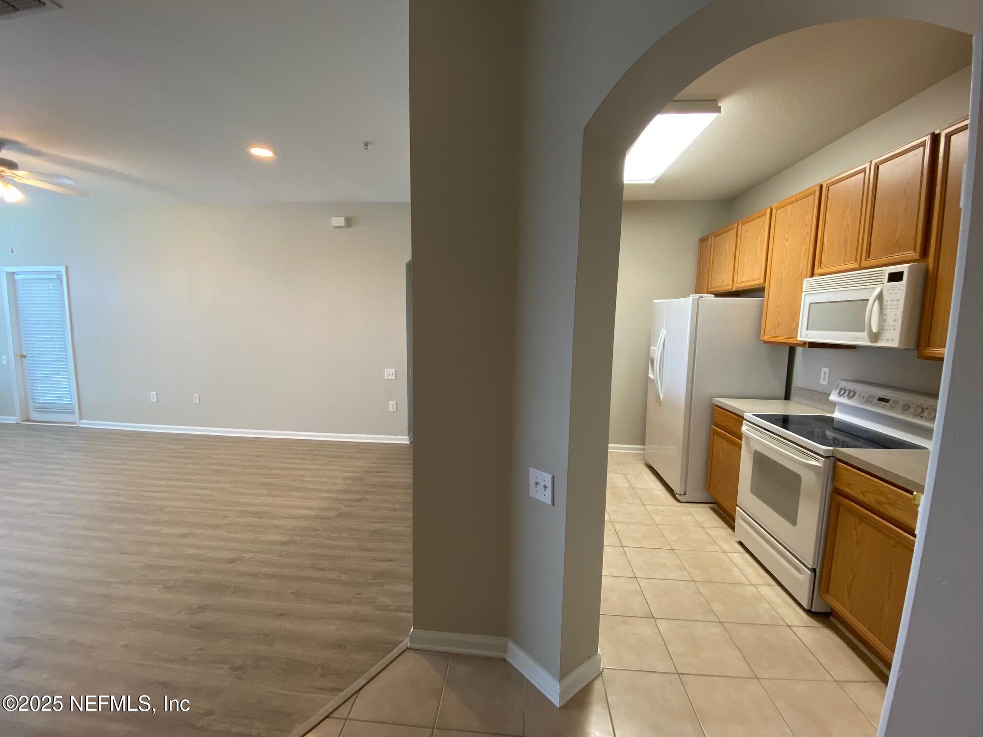 7990 Baymeadows Road, Unit 929 Jacksonville, FL 32256 - Photo 8 of 26 a kitchen with stainless steel appliances granite countertop a refrigerator and a stove