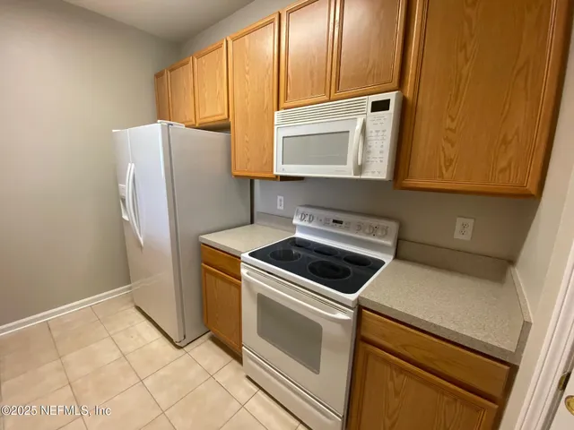 a kitchen with a stove microwave and refrigerator