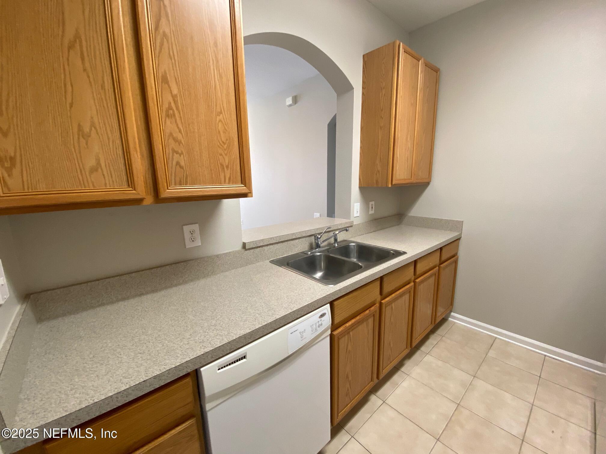 7990 Baymeadows Road, Unit 929 Jacksonville, FL 32256 - Photo 10 of 26 a utility room with a sink washer and dryer