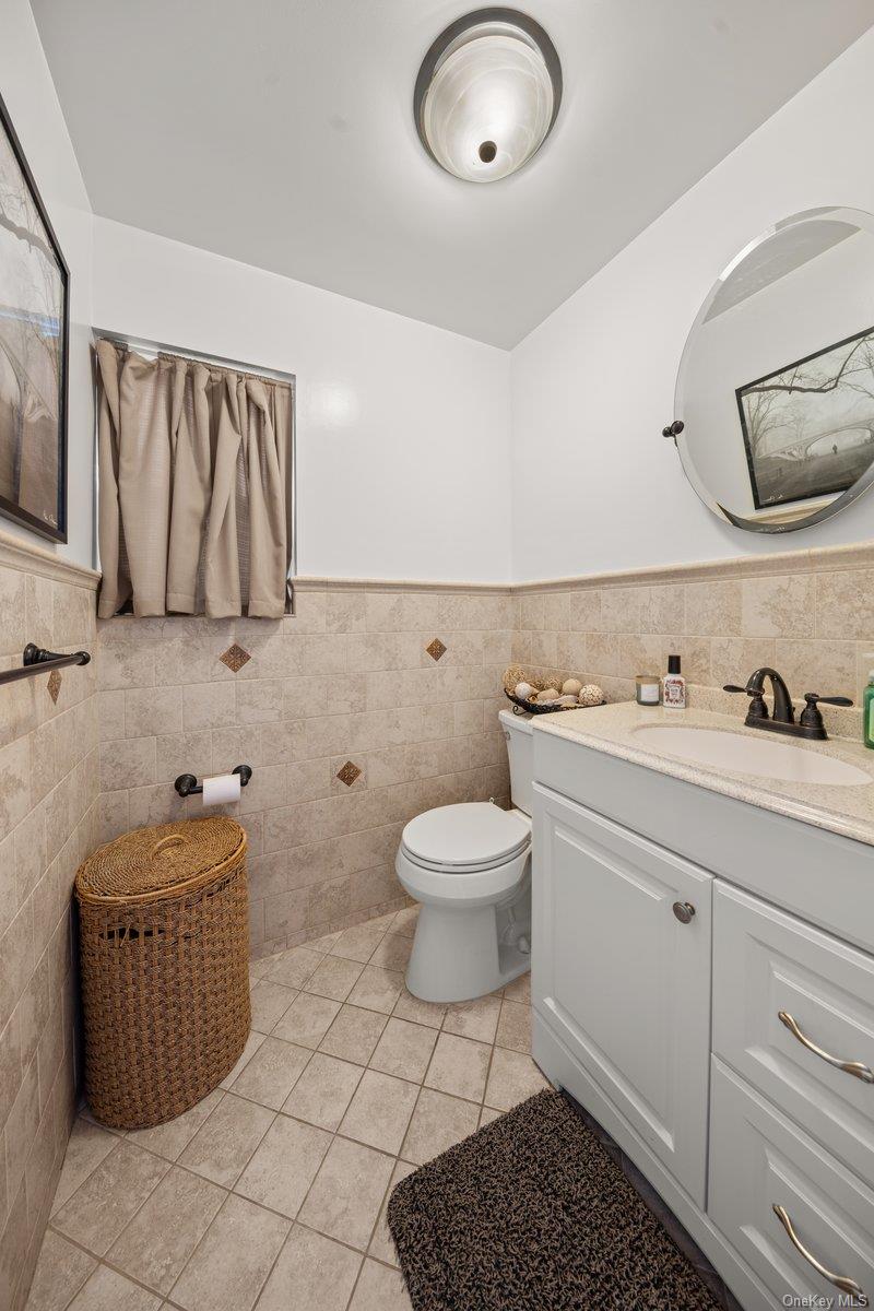 19 West 13th Road Queens, NY 11693 - Photo 11 of 19 a bathroom with a toilet a sink and mirror